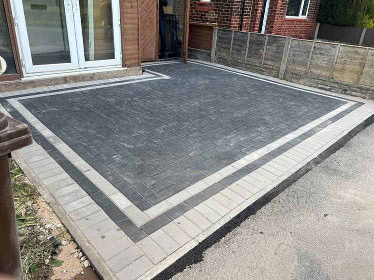 Charcoal block paving rear driveway with light border